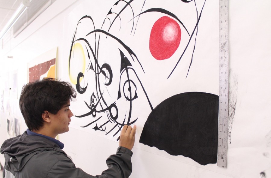 Kyle Guthrie works on his latest abstract piece in Mr. Novinsky’s art studio.