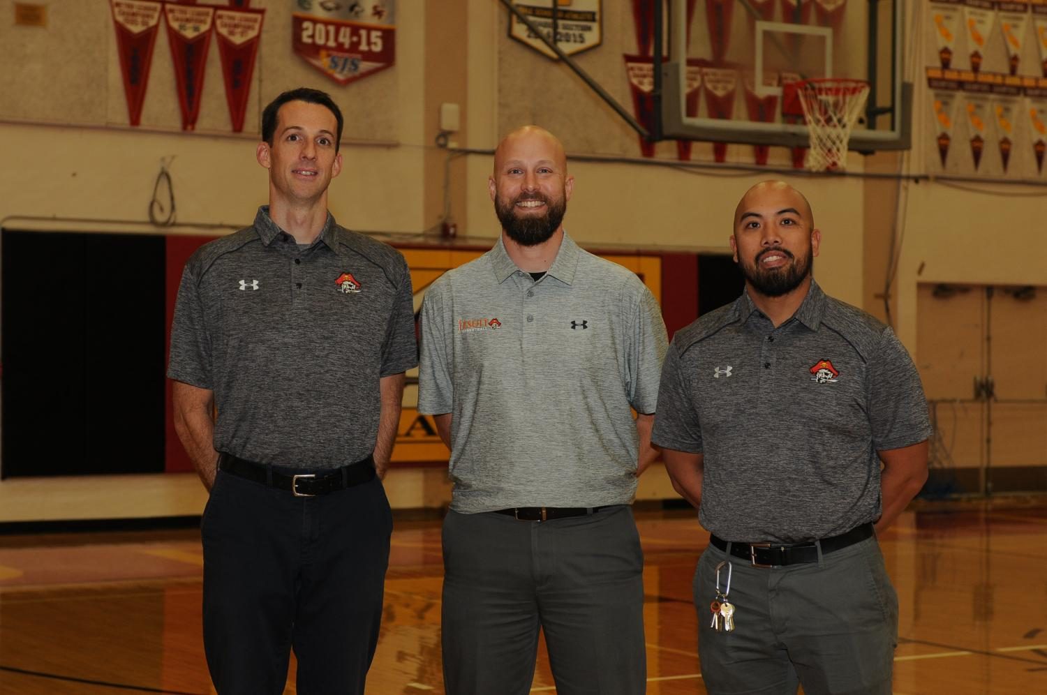 Coach Rotz 92 (middle) poses with his assistant varsity coaches. | Jesuit Communications