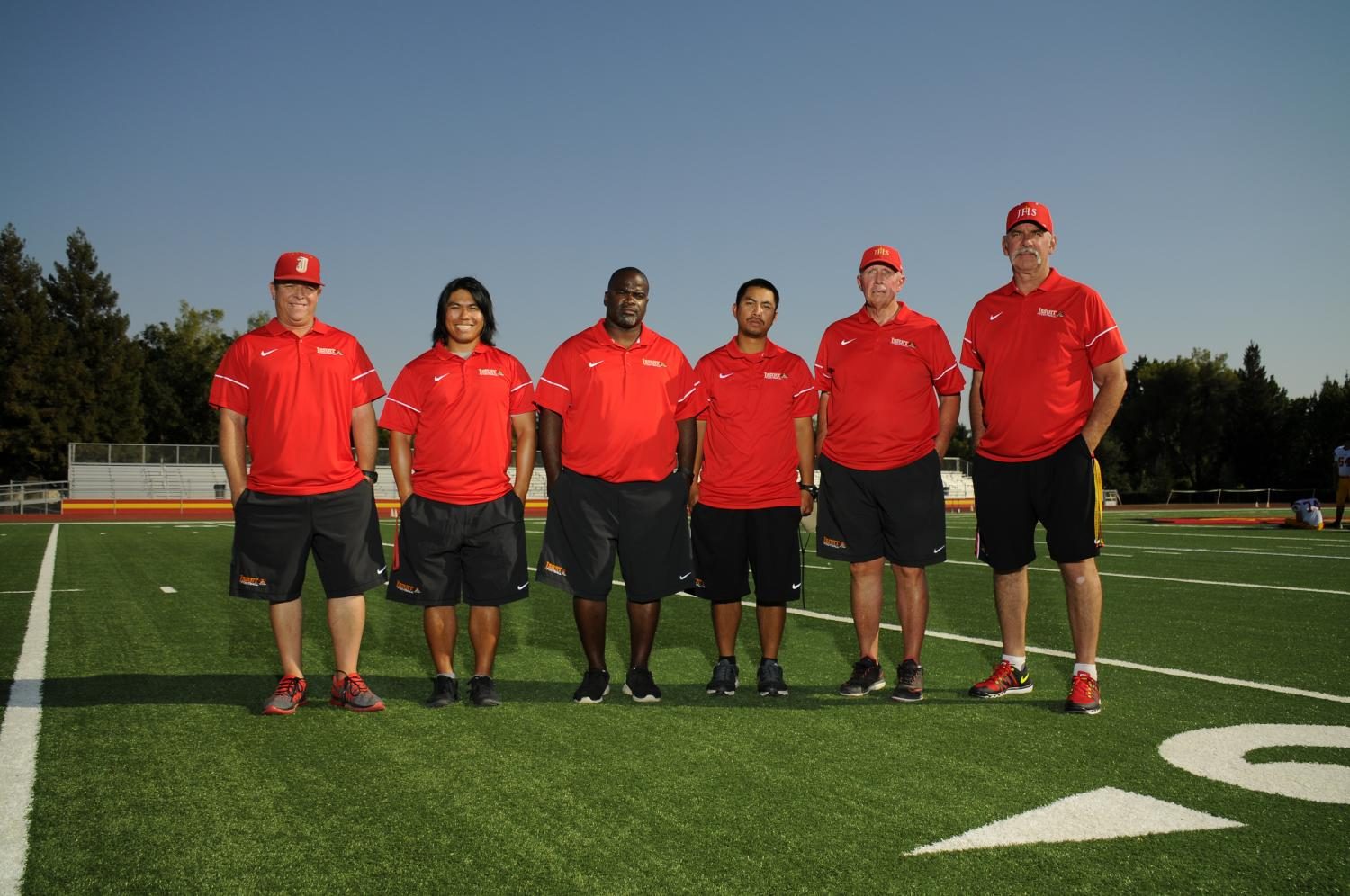 Coach Isaac (3rd from the right) poses with the varsity coaching staff. | Jesuit Communications