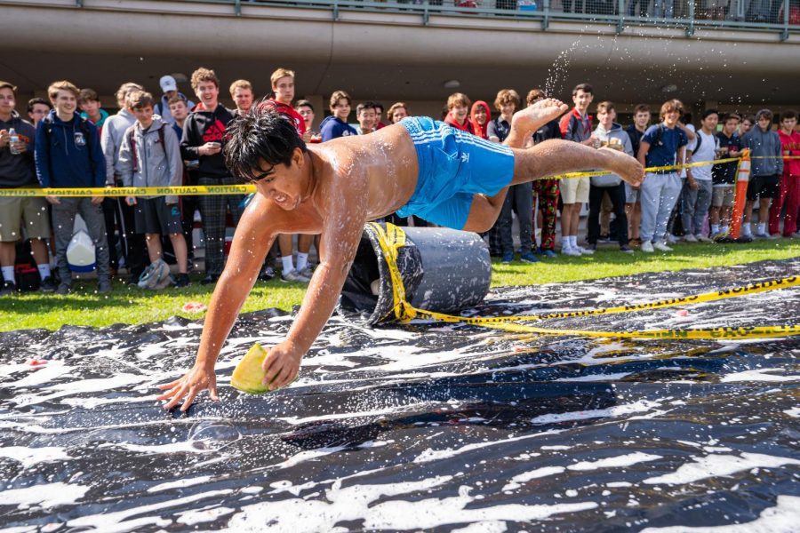 Andres Sandoval 21 dives to the finish line during the watermelon race in the sophomore/junior quad on Monday, Sept. 30, 2019.