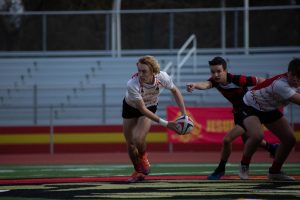 Jesuit rugby player Hunter Modlin 20 passes the ball in a home game last season.